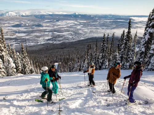 A group of skiers at the top of a run at Hudson Bay Mountain