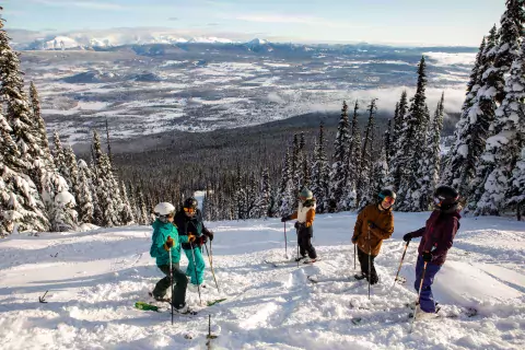 A group of skiers at the top of a run at Hudson Bay Mountain