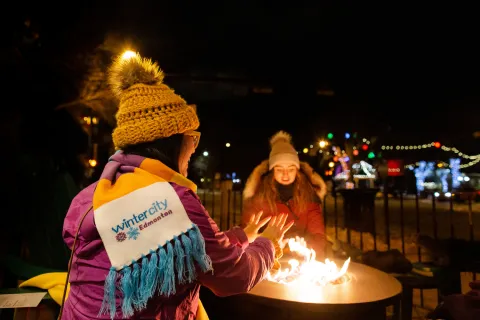 Edmonton Alberta Next Act Pub winter patio Linda Hoang and friend by the fire