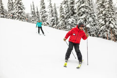 Two skiers coming down the mountain at Marmot Basin