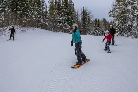 Snowboarders on the slopes at Whispering Pine Ski Hill, Mighty Peace, Alberta