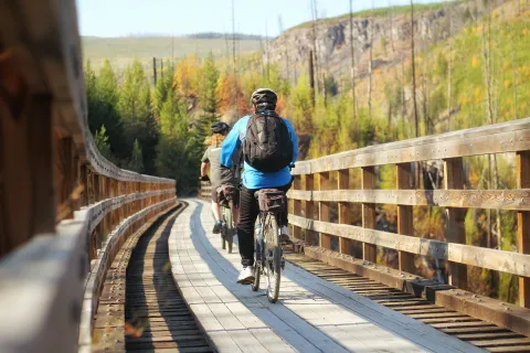 Cyclists on trestle bridge BC Dax Justin SnowSeekers