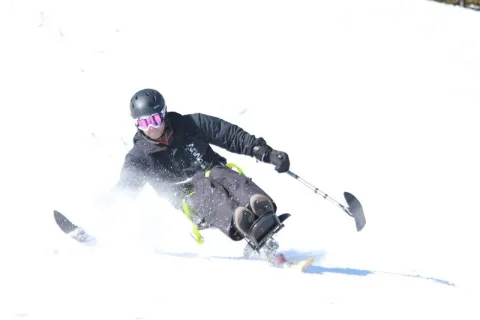 A man mono skiing athlete